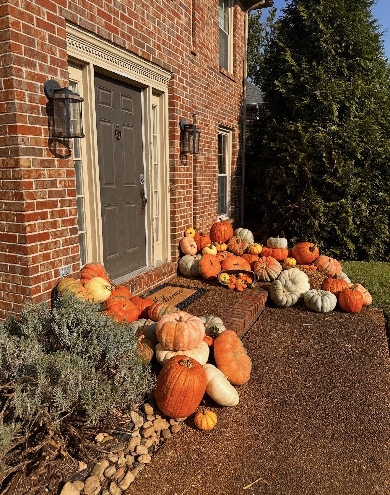 Angled view of a brick entry styled with heirloom pumpkins